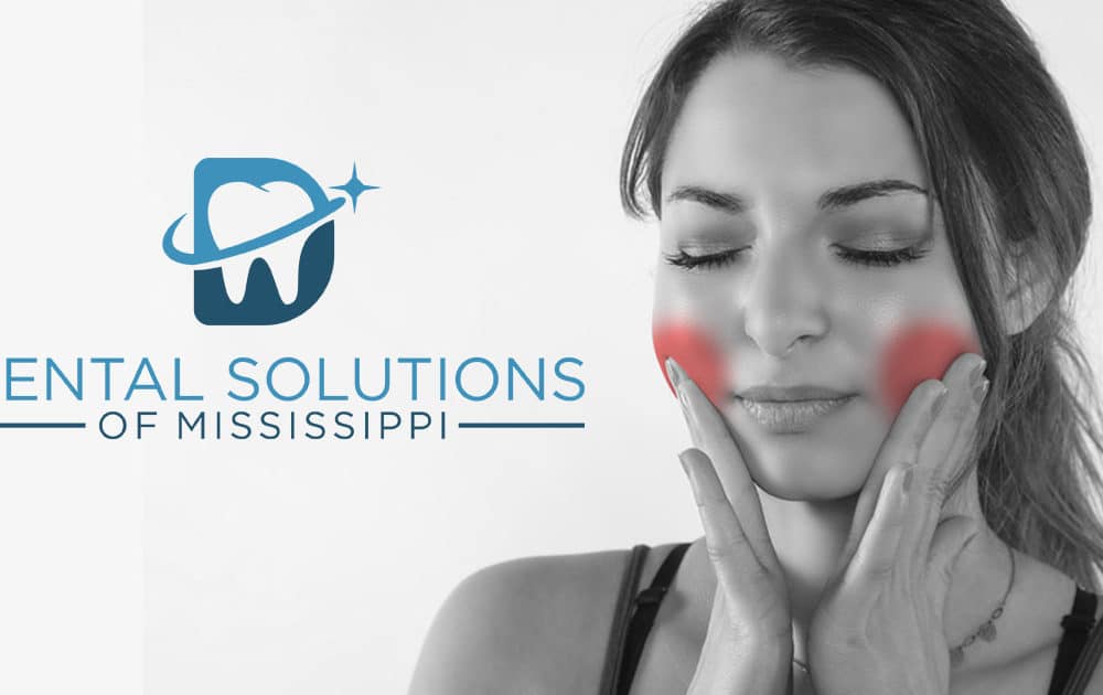 Woman feeling pain in jaw Dental Solutions of Mississippi dentist in Canton MS Dr. Ruth Roach Morgan Dr. Jessica Morgan