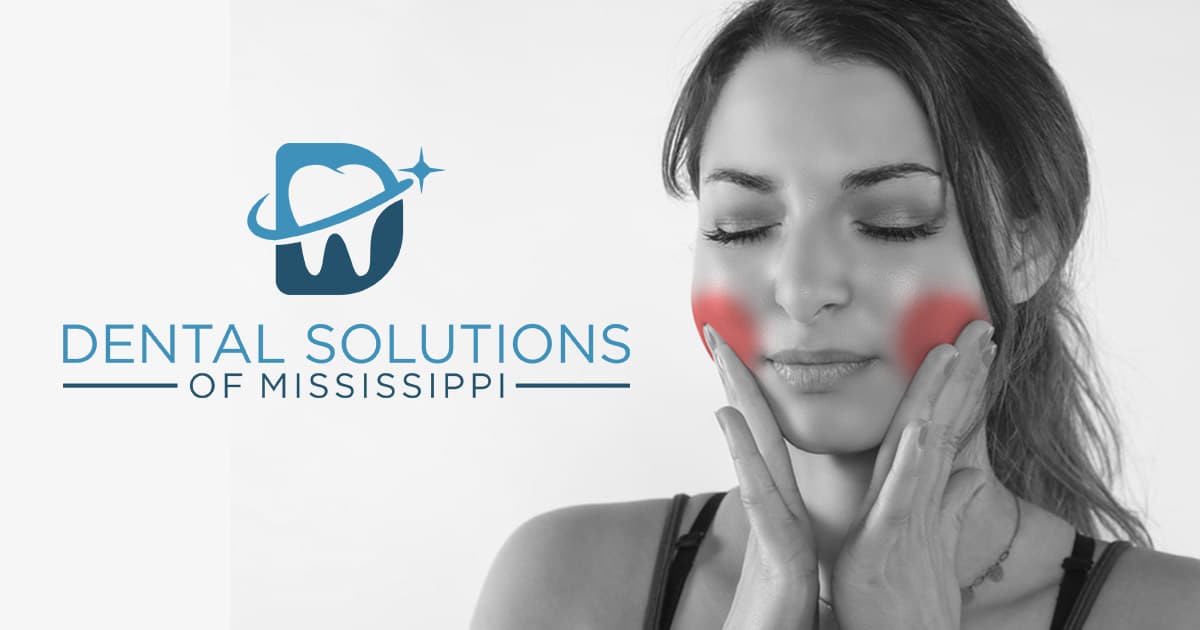 Woman feeling pain in jaw Dental Solutions of Mississippi dentist in Canton MS Dr. Ruth Roach Morgan Dr. Jessica Morgan