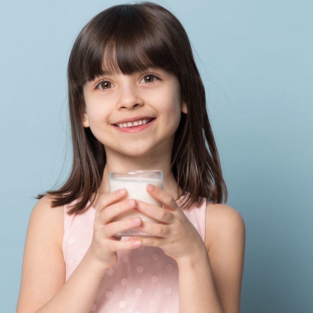 periodontal disease The Fascinating Way Vitamin D Protects Your Gums Smiling child holding glass of milk Dental Solutions of Mississippi dentist in Canton MS Dr. Ruth Roach Morgan Dr. Jessica Morgan